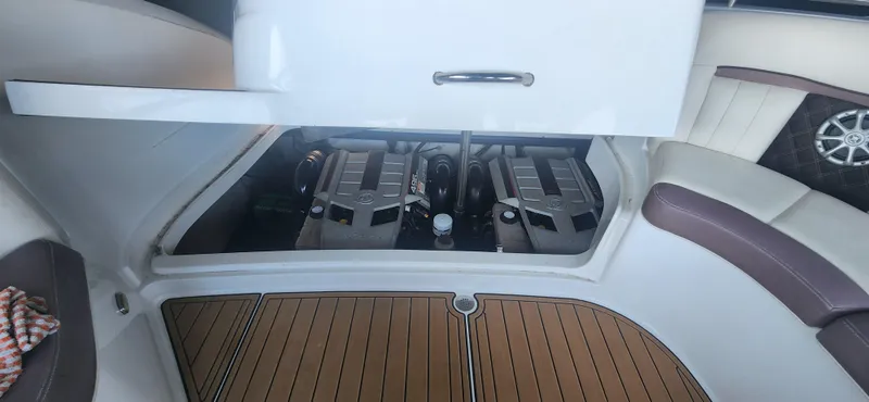 Slide: The Image of Engine compartment of a 2010 Cobalt 323 boat, featuring dual engines and teak flooring. - 37