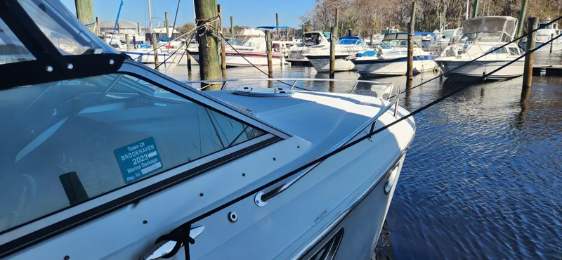 Slide: The Image of 2010 Cobalt 323 boat docked in a marina with other vessels. - 4