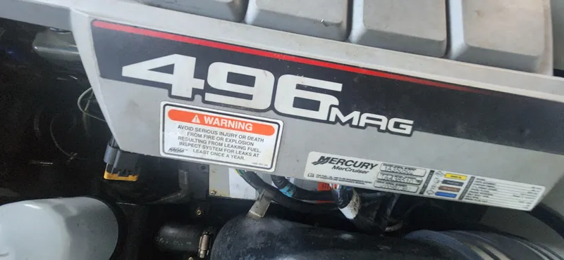 Slide: The Image of Engine cover of a 2010 Cobalt 323 with 496 MAG branding and warning label. - 40