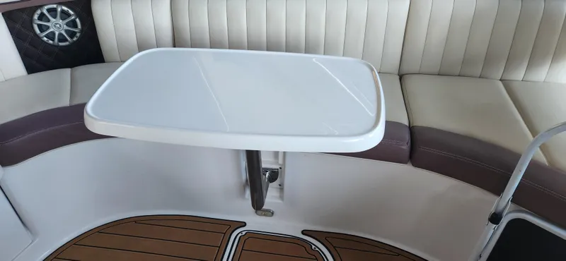 Slide: The Image of Interior of a 2010 Cobalt 323 boat with seating and a table. - 43