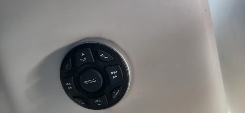Slide: The Image of Control panel on a 2010 Cobalt 323 boat dashboard with volume and mode buttons. - 44