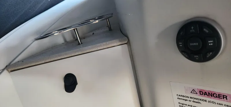 Slide: The Image of Interior detail of a 2010 Cobalt 323 boat, featuring a control panel and warning label. - 45