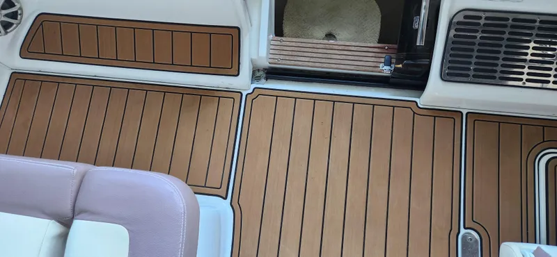 Slide: The Image of 2010 Cobalt 323 boat interior with teak-style flooring and cushioned seating. - 47