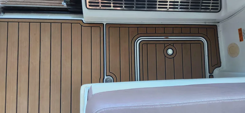 Slide: The Image of 2010 Cobalt 323 boat interior with teak flooring and seating. - 48