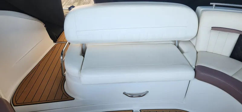 Slide: The Image of 2010 Cobalt 323 boat interior with white leather seating and wood flooring. - 7