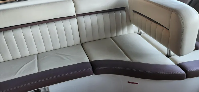 Slide: The Image of Luxurious seating in a 2010 Cobalt 323 boat, featuring cream and brown upholstery. - 9