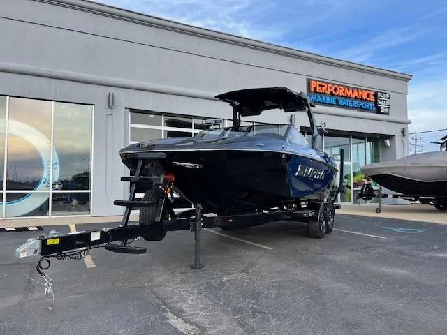 The Image of 2025 Supra SA450 boat on trailer outside Performance Marine Watersports dealership. - 1