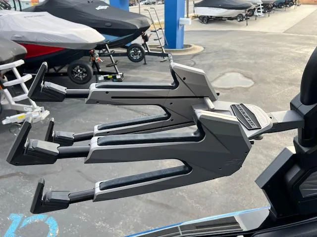 Slide: The Image of 2025 Supra SA450 boat with advanced wakeboard racks in a marina setting. - 20