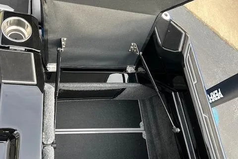 Slide: The Image of 2025 Supra SA450 storage compartment with open lid and cup holder. - 24