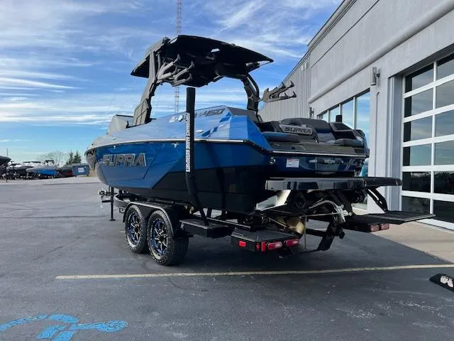 Slide: The Image of 2025 Supra SA450 boat on trailer, parked outside a building. - 4