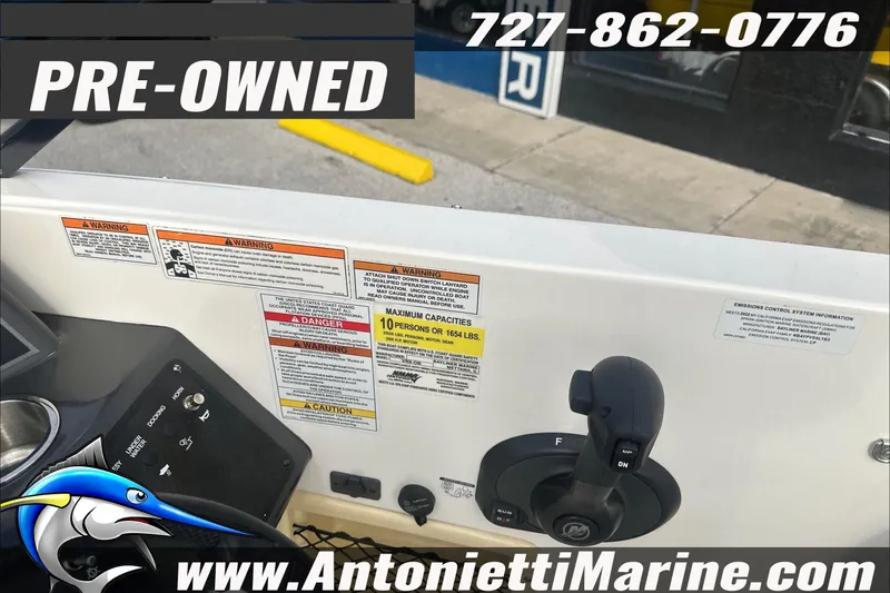 Slide: The Image of Pre-owned 2022 Bayliner VR6 Bowrider OB dashboard with control panel and warning labels. - 10