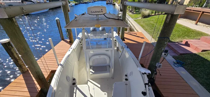 Slide: The Image of 2011 Sailfish 2360 CC boat docked, featuring Garmin equipment, on a sunny day. - 11
