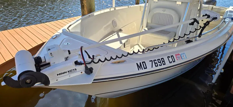 Slide: The Image of 2011 Sailfish 2360 CC boat docked, featuring Minn Kota trolling motor. - 12