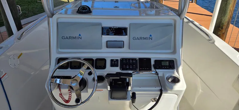 Slide: The Image of 2011 Sailfish 2360 CC boat console with Garmin navigation system and steering wheel. - 7