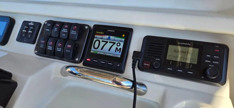 Slide: The Image of Control panel of 2011 Sailfish 2360 CC boat with navigation and communication devices. - 8