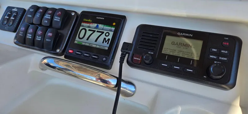 Slide: The Image of Control panel of 2011 Sailfish 2360 CC with Garmin navigation and communication devices. - 9