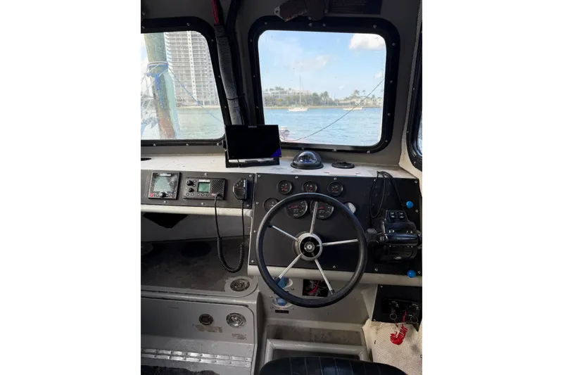 Slide: The Image of Interior view of 2003 Zodiac Milpro Hurricane boat cockpit with steering wheel and navigation instruments. - 11