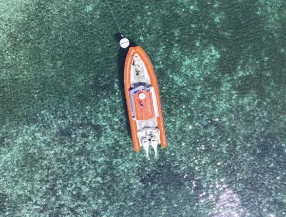 Slide: The Image of Aerial view of 2003 Zodiac Hurricane boat on clear turquoise water. - 2