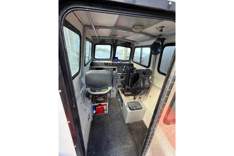 Slide: The Image of Interior of 2003 Zodiac Milpro Hurricane boat, featuring cockpit and seating area. - 7