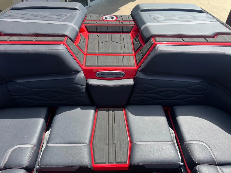 Slide: The Image of 2025 Supra SL450 boat interior with sleek black and red seating design. - 10