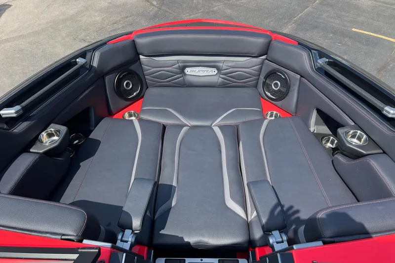 Slide: The Image of 2025 Supra SL 450 boat interior with black leather seating and integrated speakers. - 24