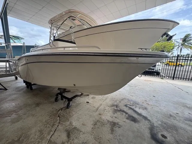 Slide: The Image of 2024 Grady-White Fisherman 180 boat displayed in a showroom, side view. - 1