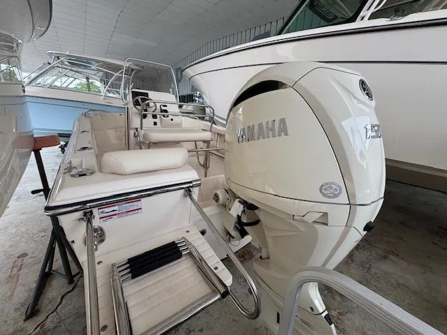 Slide: The Image of 2024 Grady-White Fisherman 180 boat with Yamaha engine in a covered storage area. - 10