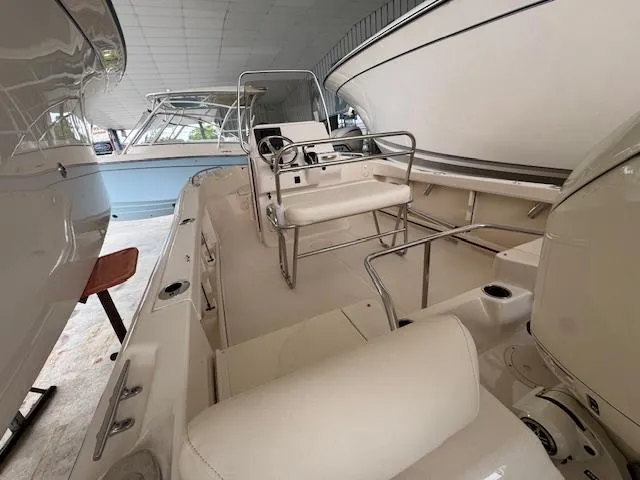 Slide: The Image of 2024 Grady-White Fisherman 180 boat interior, featuring seating and steering console in a showroom. - 12