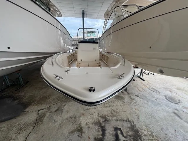Slide: The Image of 2024 Grady-White Fisherman 180 boat in showroom, front view, between two other boats. - 2