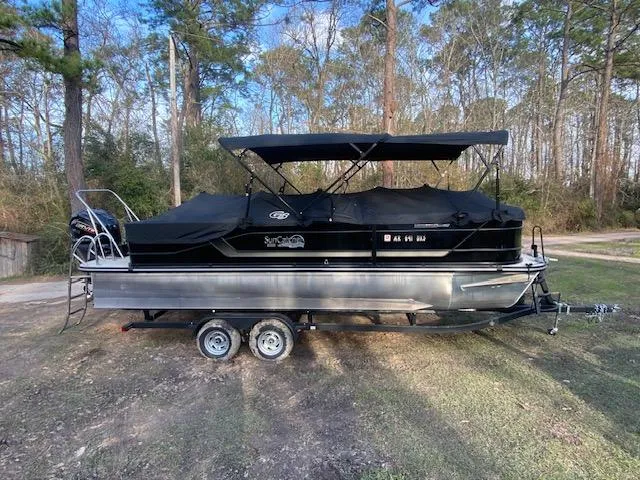 Slide: The Image of 2023 SunCatcher Fusion 324SS pontoon boat on trailer, parked outdoors. - 17