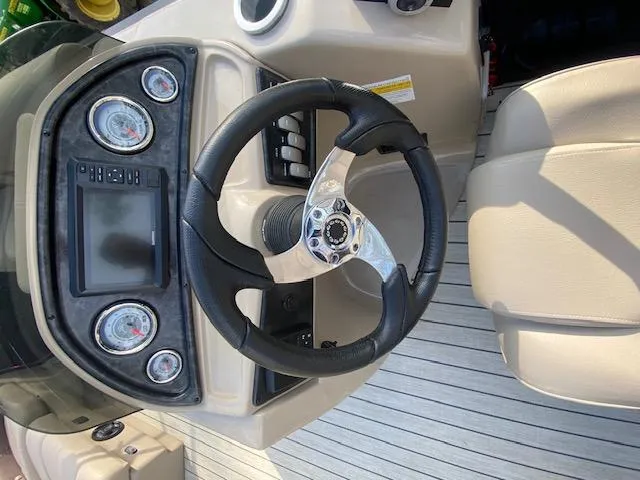 Slide: The Image of 2023 SunCatcher Fusion 324SS dashboard with steering wheel and gauges. - 25