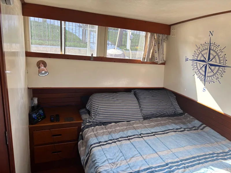 Slide: The Image of Cozy bedroom in 1982 Grand Banks 36 Classic boat with nautical decor and striped bedding. - 14