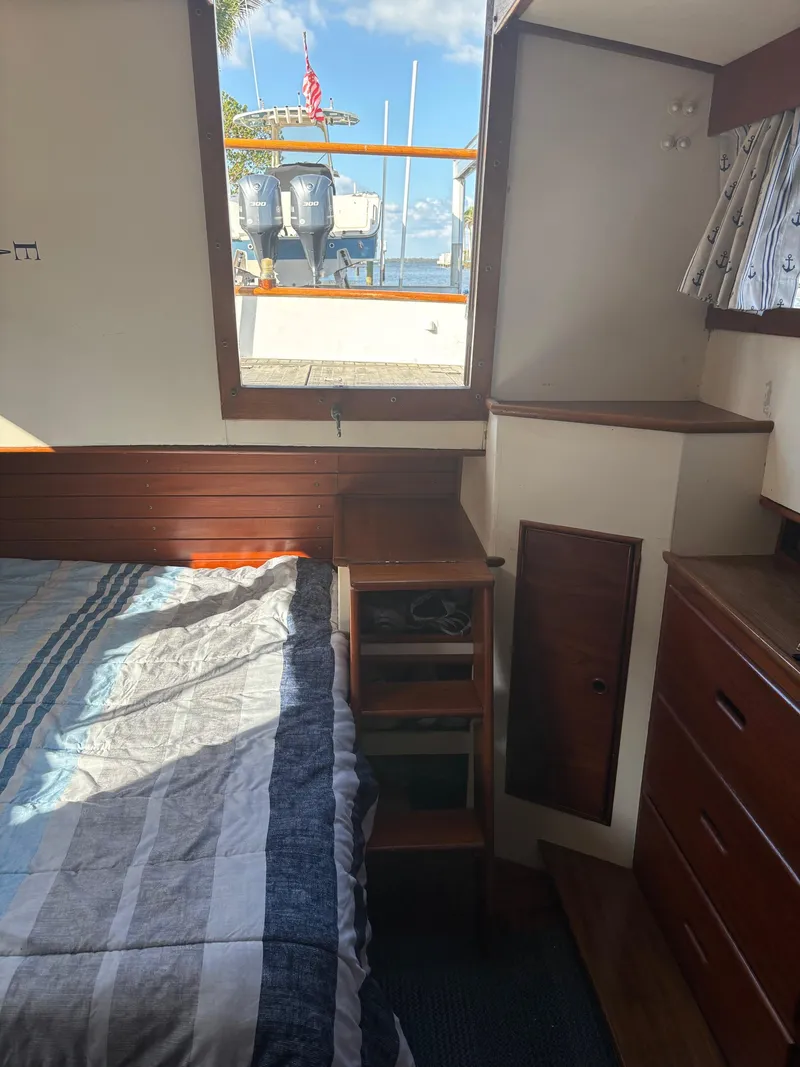 Slide: The Image of Interior of 1982 Grand Banks 36 Classic boat, featuring a cozy cabin with wooden furnishings. - 17