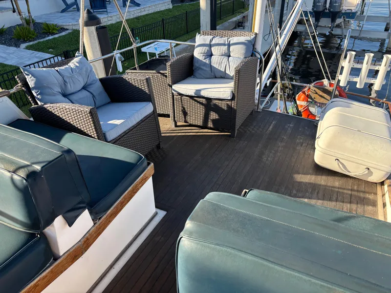 Slide: The Image of 1982 Grand Banks 36 Classic yacht deck with cushioned seating and outdoor furniture. - 19