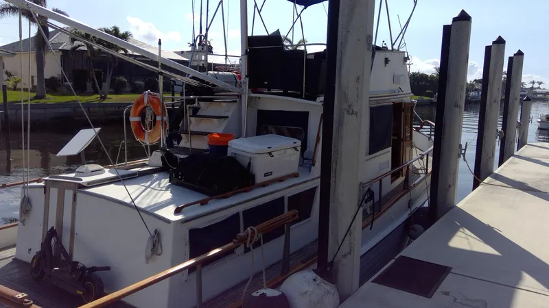 Slide: The Image of 1982 Grand Banks 36 Classic docked at marina, side view. - 2