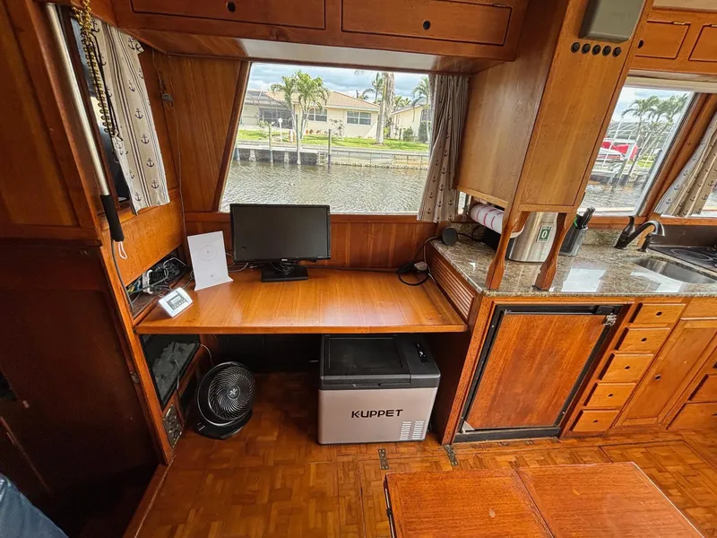 Slide: The Image of Interior of 1982 Grand Banks 36 Classic with desk, monitor, and Kuppet fridge. - 25