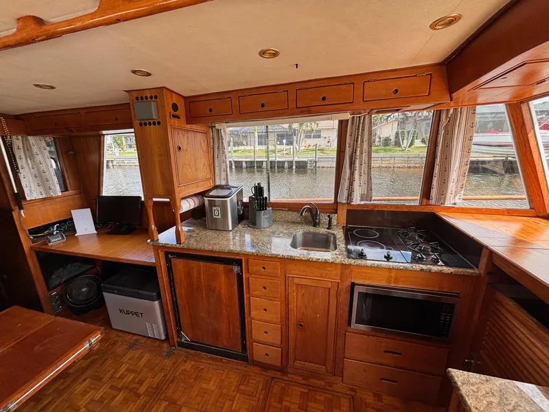 Slide: The Image of Interior of 1982 Grand Banks 36 Classic yacht kitchen with wood cabinetry and granite countertops. - 28
