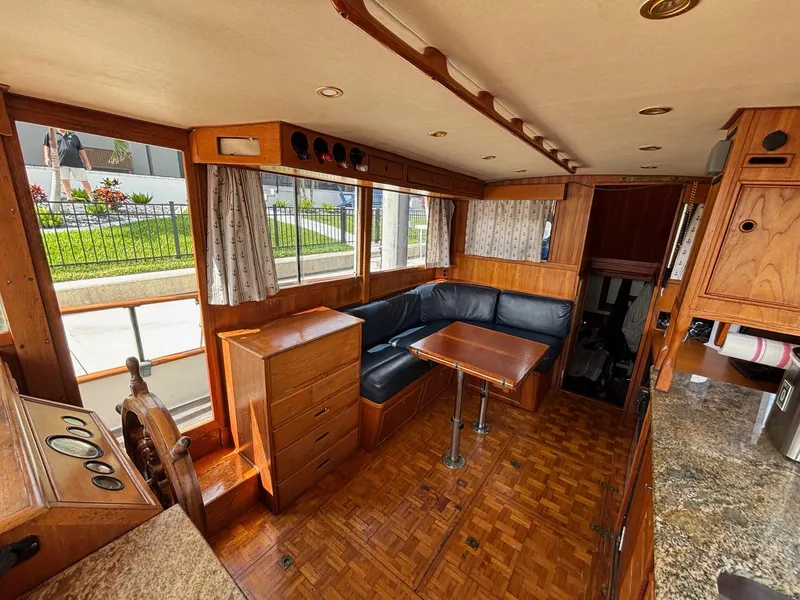Slide: The Image of 1982 Grand Banks 36 Classic interior with wooden furnishings and blue seating. - 31