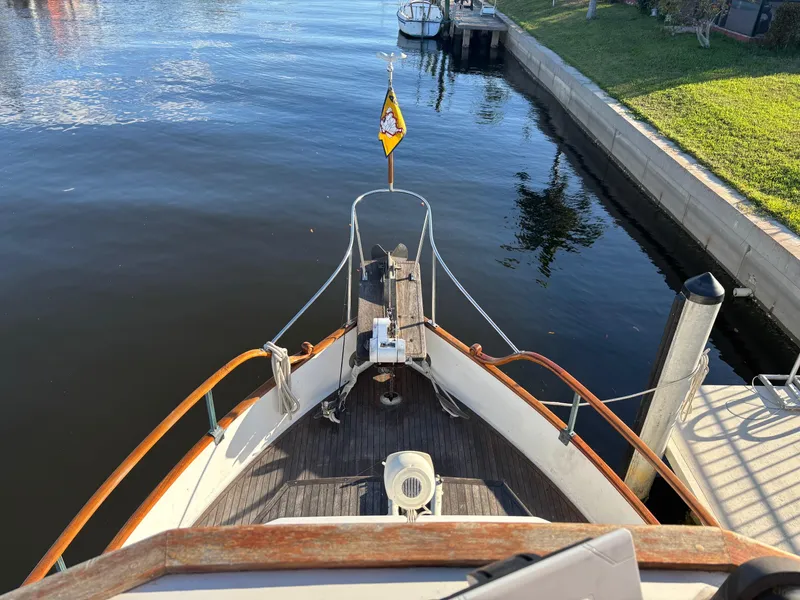 Slide: The Image of 1982 Grand Banks 36 Classic boat docked by a calm waterfront. - 33
