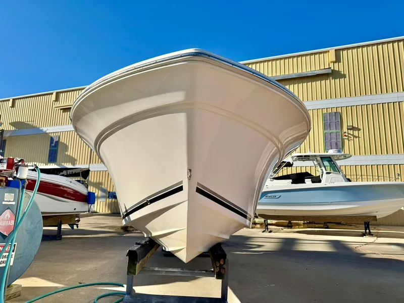 Slide: The Image of 2018 Sea Fox 226 Commander boat on trailer, parked outdoors under clear blue sky. - 2