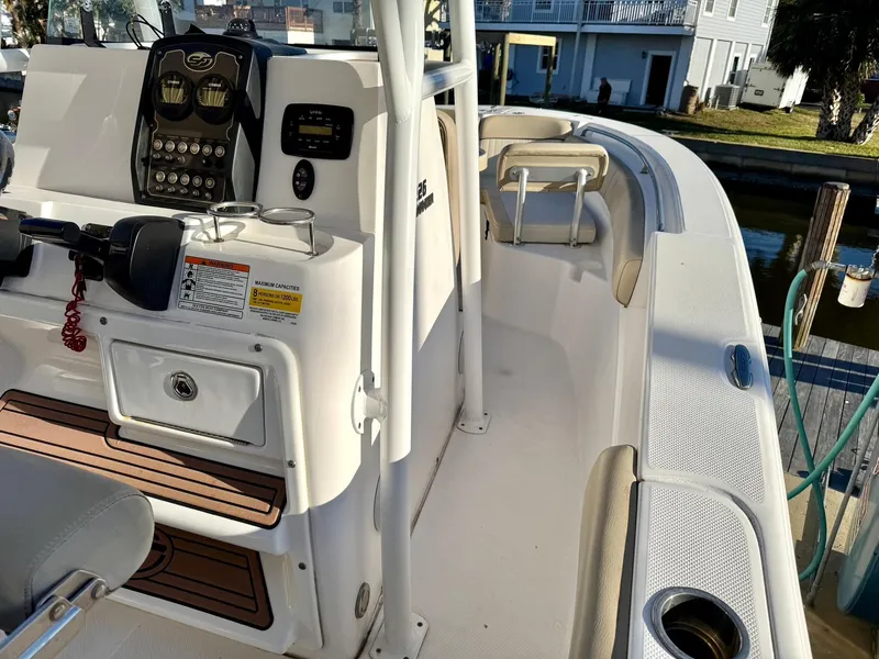 Slide: The Image of 2018 Sea Fox 226 Commander boat interior with console and seating, docked near waterfront homes. - 9
