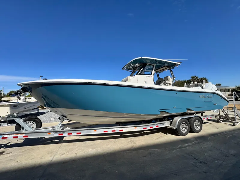 The Image of 2025 Solace 32 CS boat on trailer under clear blue sky. - 1