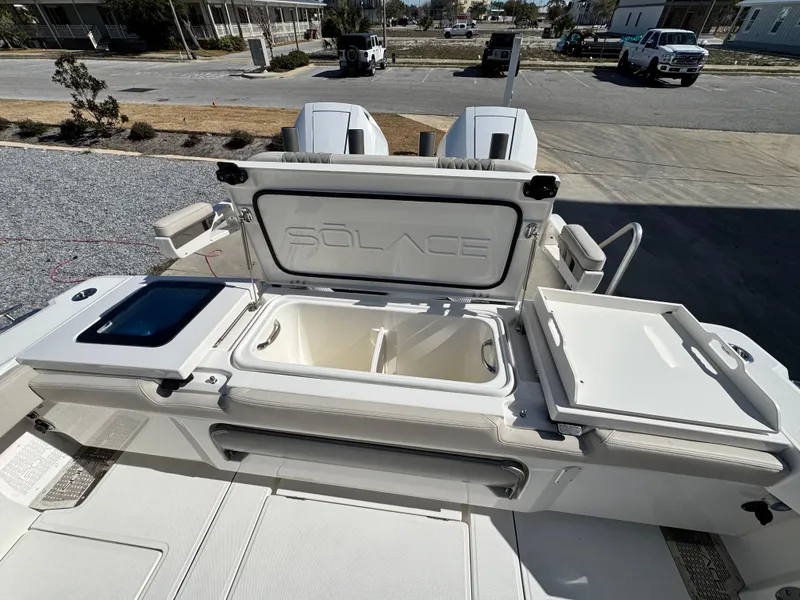 Slide: The Image of 2025 Solace 32 CS boat deck with storage compartments and seating area. - 13