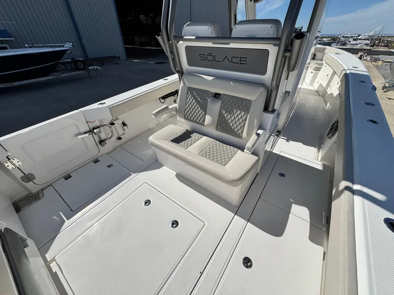 Slide: The Image of 2025 Solace 32 CS boat interior with seating and storage compartments. - 15