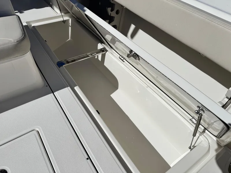 Slide: The Image of Open storage compartment on 2025 Solace 32 CS boat, showcasing spacious interior. - 21