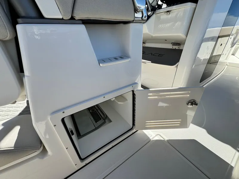 Slide: The Image of Open storage compartment on a 2025 Solace 32 CS boat interior. - 22