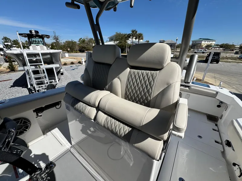 Slide: The Image of 2025 Solace 32 CS boat with luxurious beige seating and diamond stitching. - 23