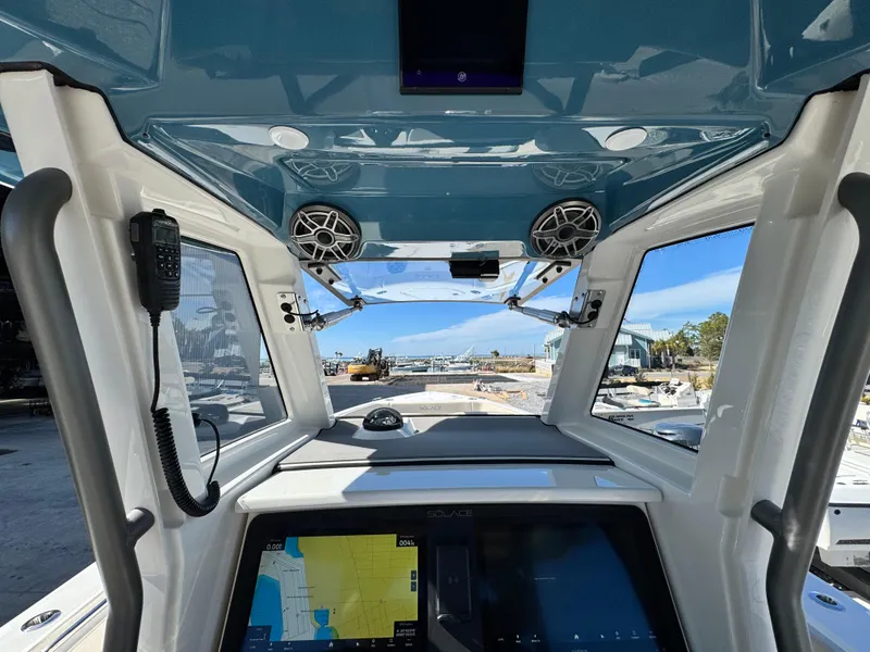 Slide: The Image of Interior view of 2025 Solace 32 CS boat cockpit with navigation screens and speakers. - 25