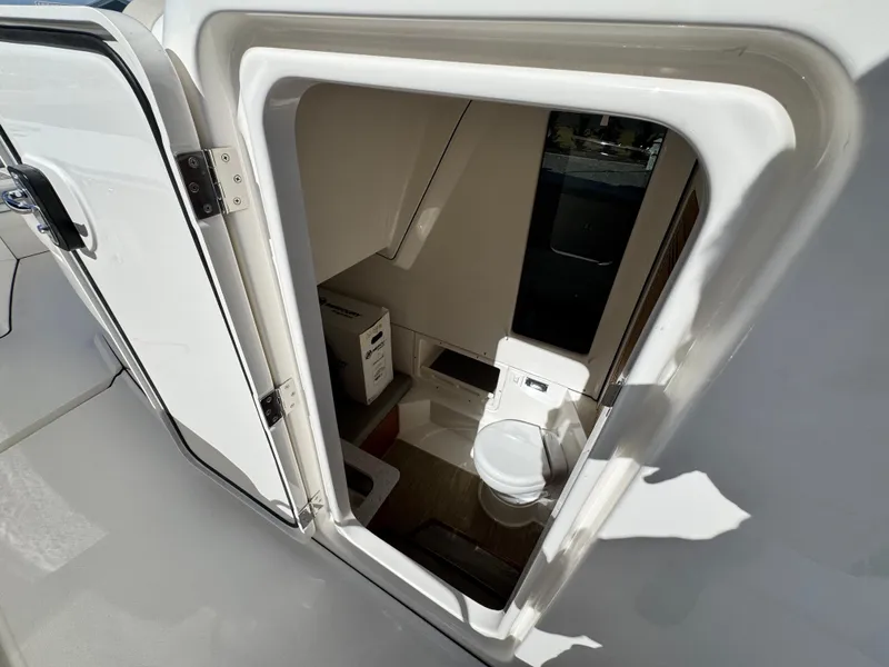 Slide: The Image of Interior view of 2025 Solace 32 CS boat bathroom with toilet and storage. - 36