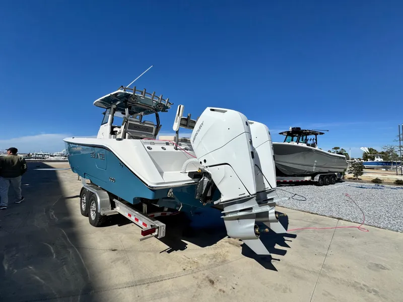 Slide: The Image of 2025 Solace 32 CS boat on trailer, dual engines, clear sky background. - 4